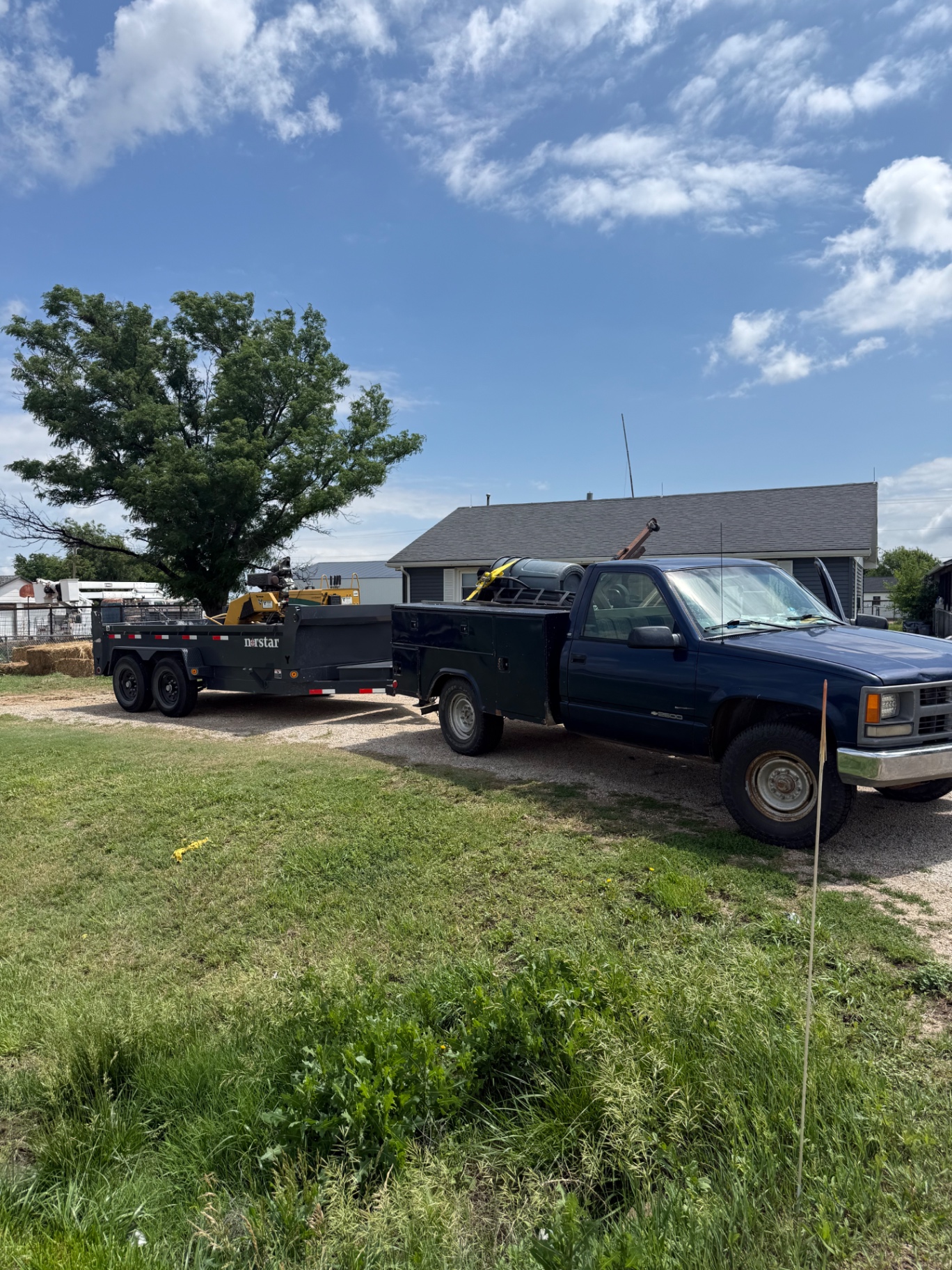 Gray Tree Trimming work truck and trailer with stump grinder